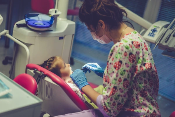 dentist examining little girl