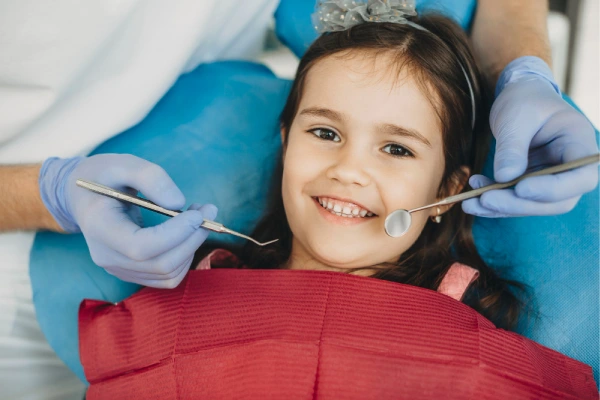 kid smiling after teeth surgery